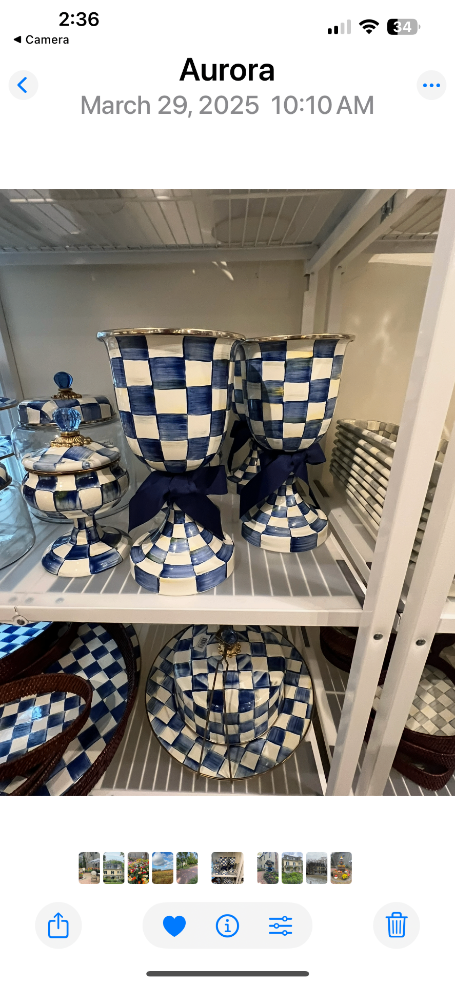Navy and white Royal Check urns and covered jars tied with navy bows on a store display shelf