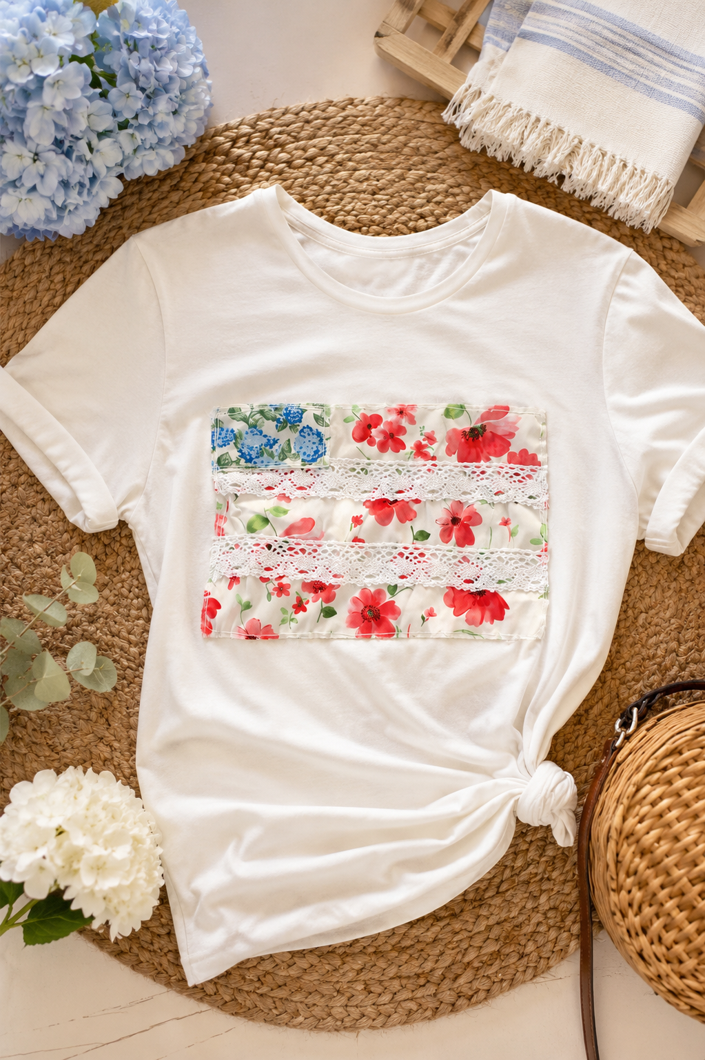 Handmade Nantucket tee styled on a jute rug with blue hydrangeas